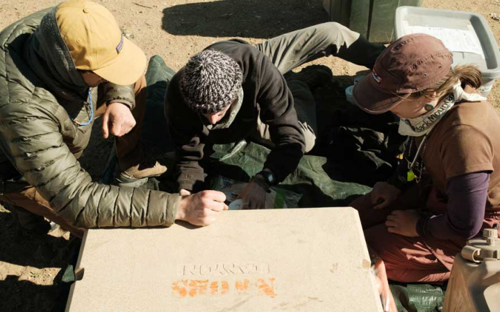three people look at a map in Joshua Tree National Park